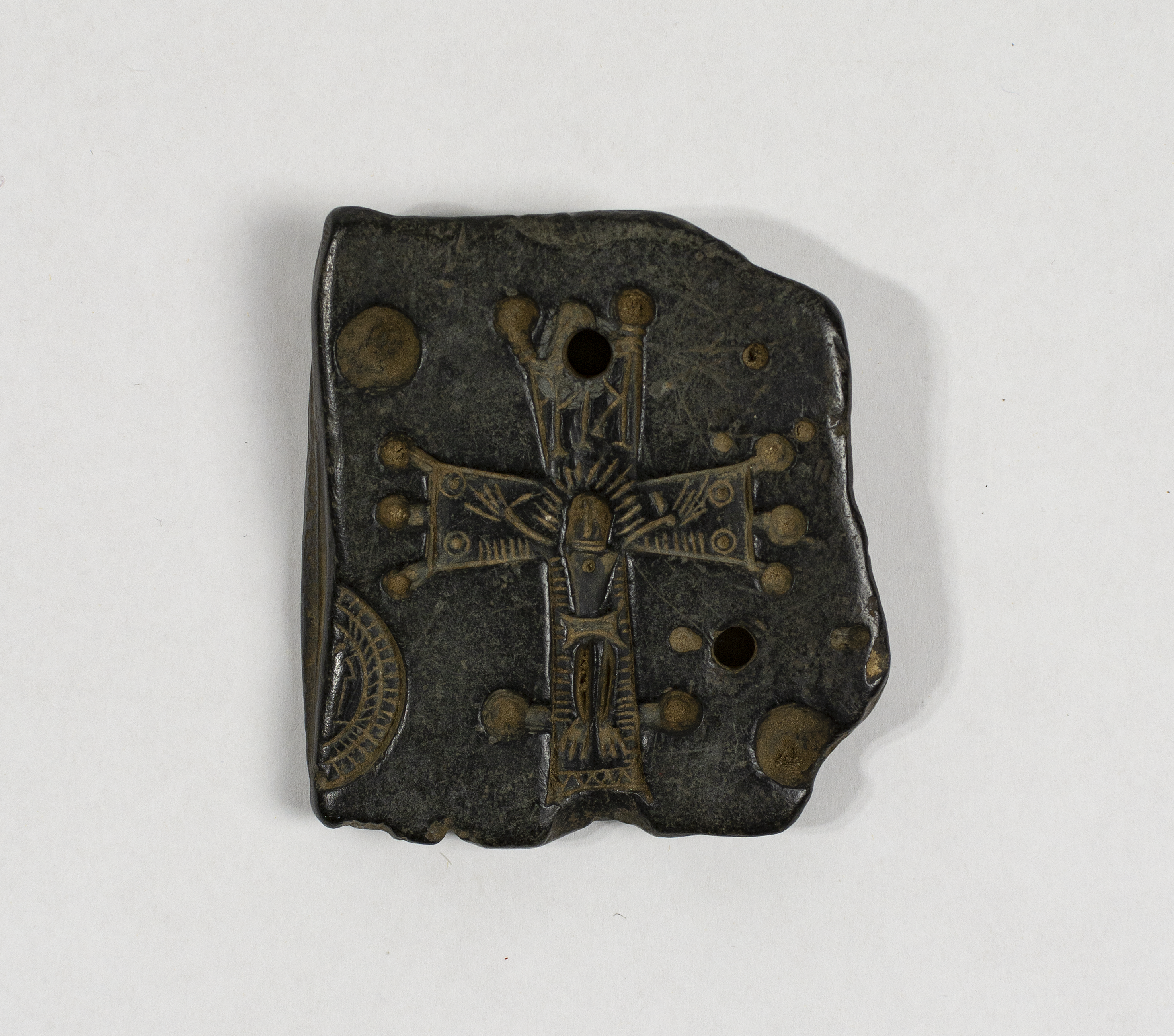 A stone mould with representations of crucifixes.